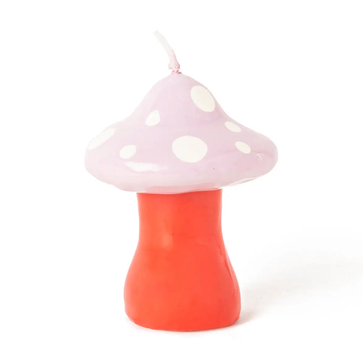 A mushroom-shaped candle with a light pink cap decorated with white polka dots and a bright red-orange stem, shown on a plain white background.