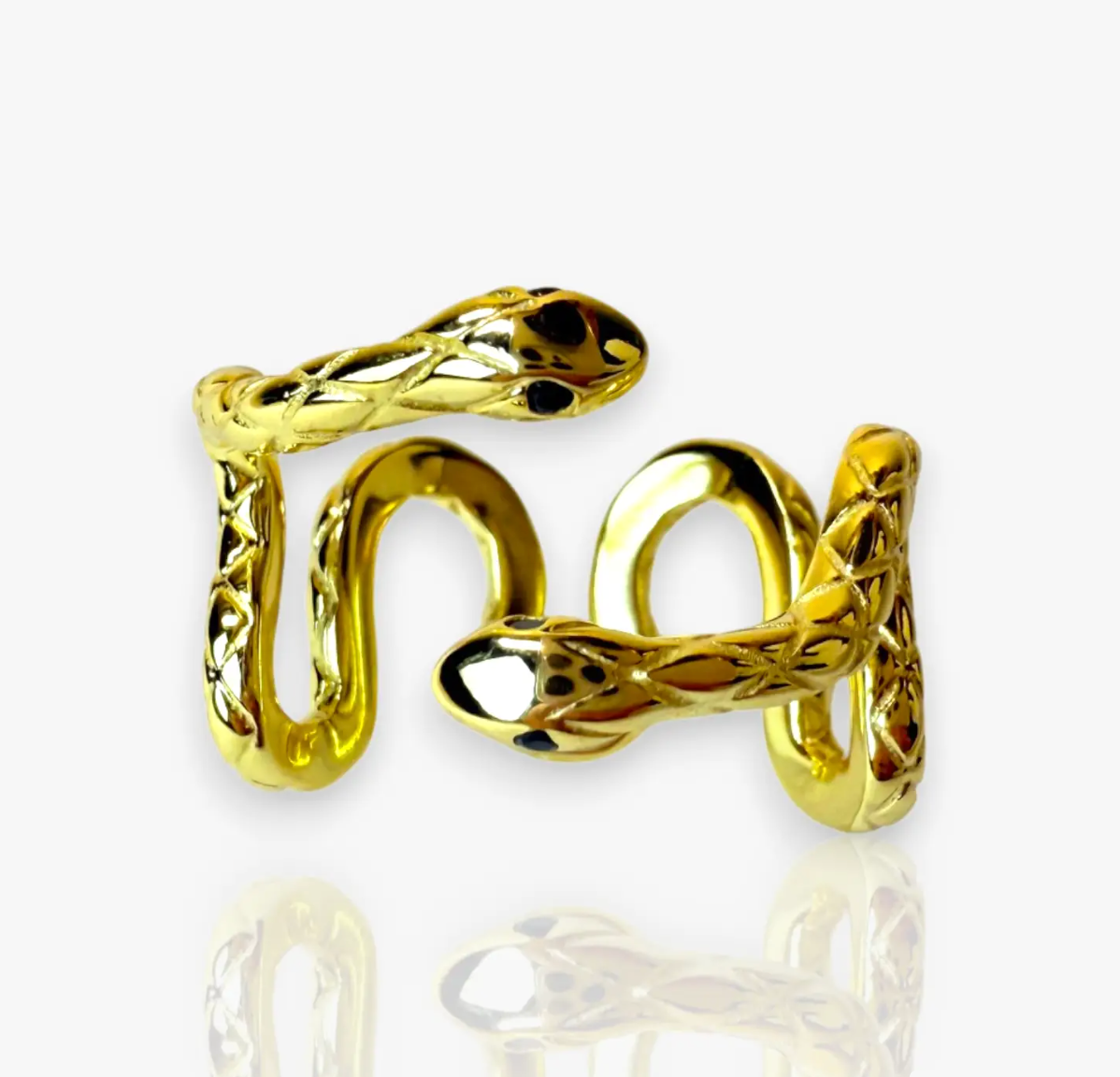 Sleek and hypnotic, the Serpent Coil Ring embodies power and transformation. Crafted in gleaming 14k gold plate over sterling silver, the coiled design wraps gracefully around the finger, ending in twin sculpted snake heads with dark alluring eyes. Adjustable for a perfect fit.