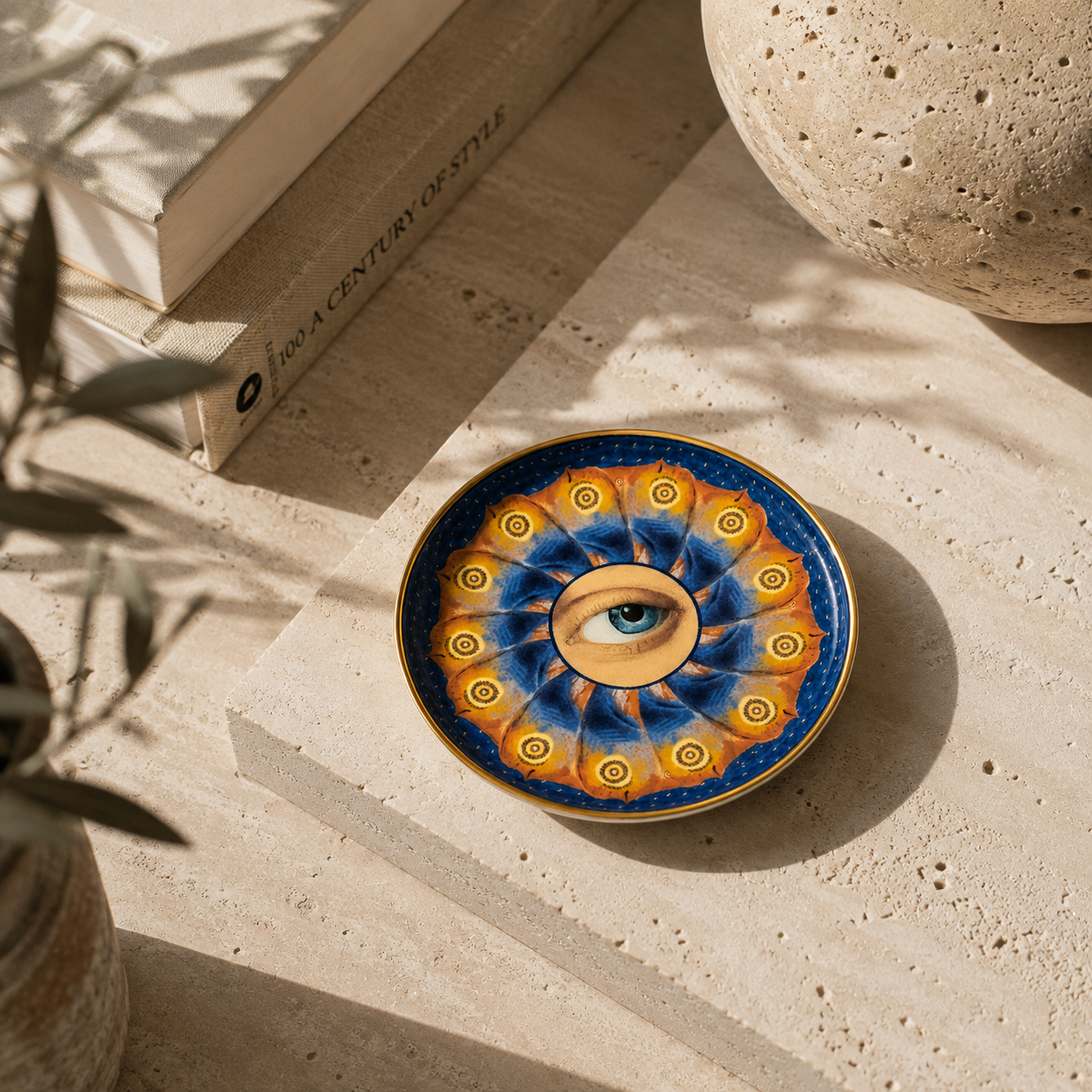 A round ceramic trinket dish with a colorful mandala design featuring a 