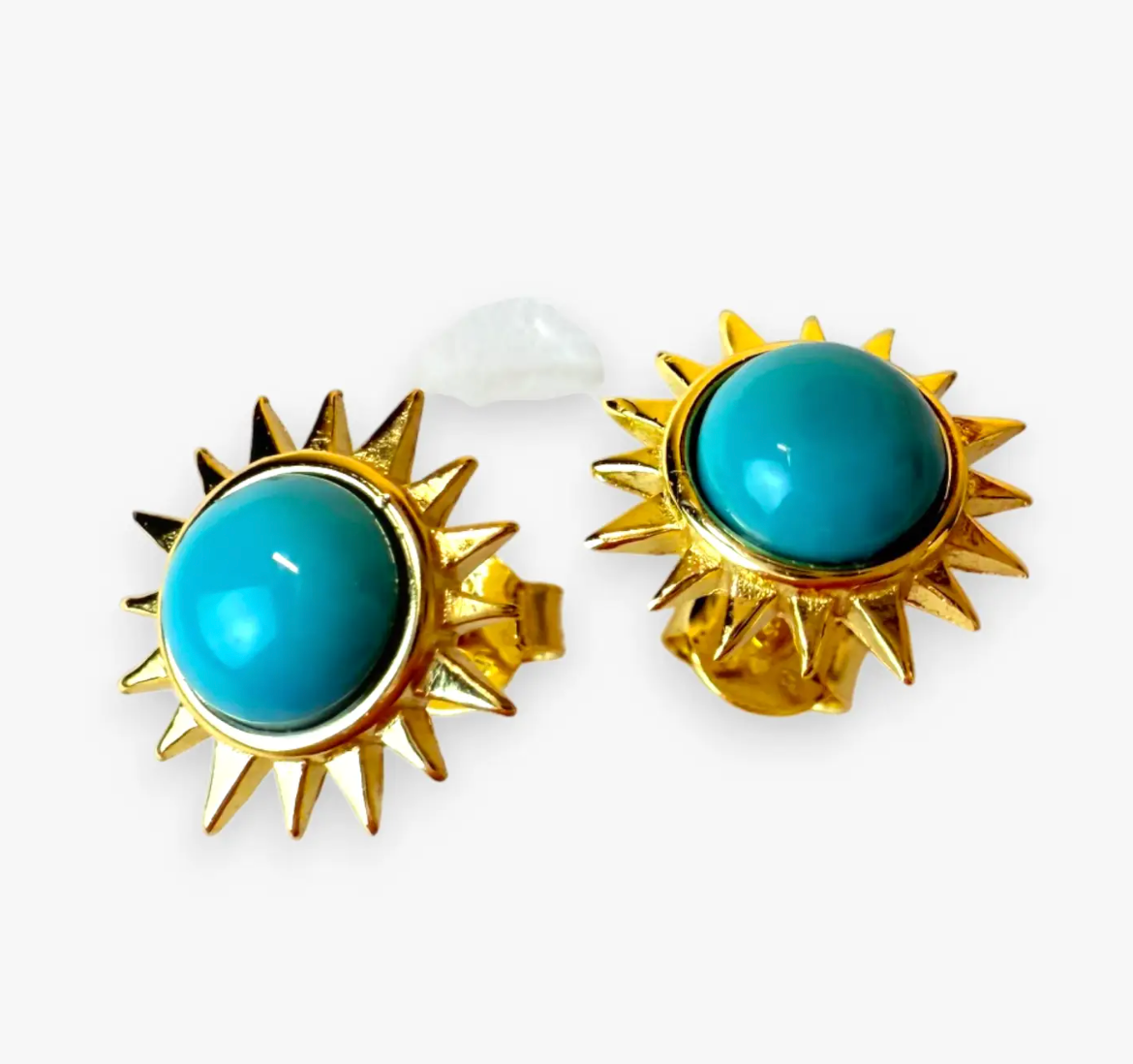 Vibrant and full of energy, the Solar Turquoise Studs channel the power of the sun in bold, golden form. Each earring features a radiant turquoise cabochon encircled by a halo of 14k gold-plated sterling silver rays. Striking and luminous, they bring a touch of modern edge and timeless elegance to any look—perfect for everyday wear or an elevated night out.